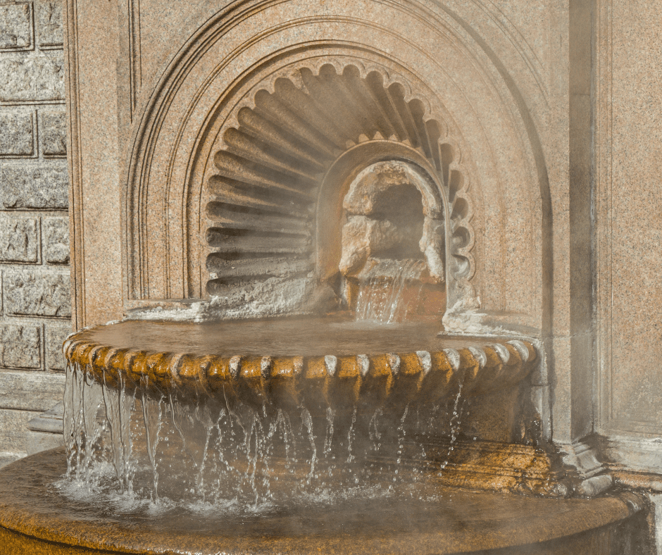 Grand entrance of Terme Tettuccio in Montecatini Terme, Italy, featuring neoclassical columns, marble architecture, and manicured gardens.