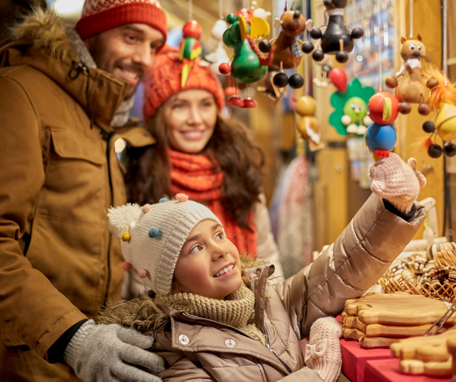 happy family choosing souvenirs at Christmas Market