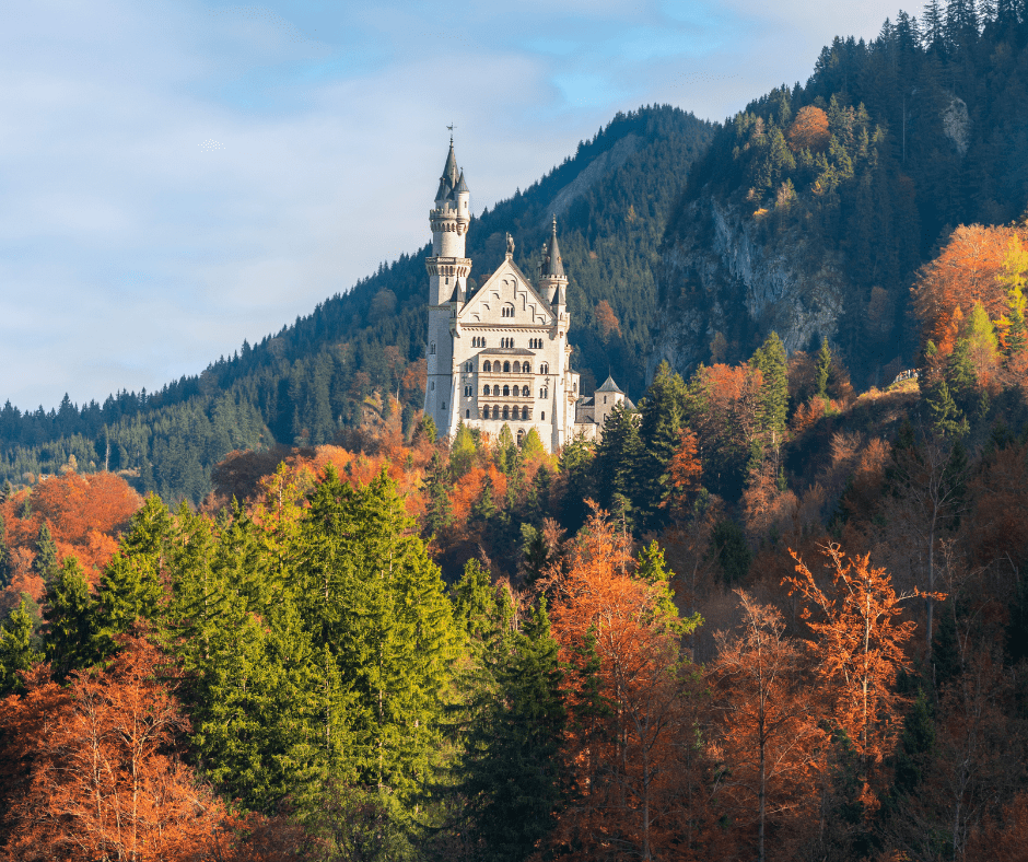 Autumn scenery with colorful trees and the Bavarian Alps mountains on a sunny day in Fussen, Germany