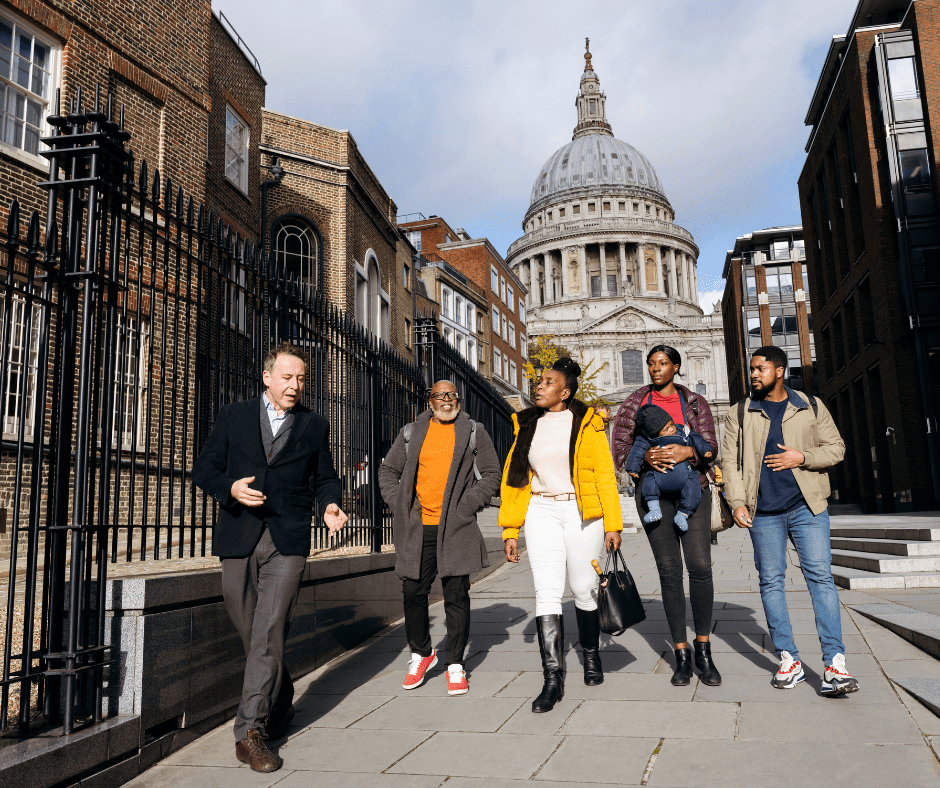 Guide and family on walking tour of London