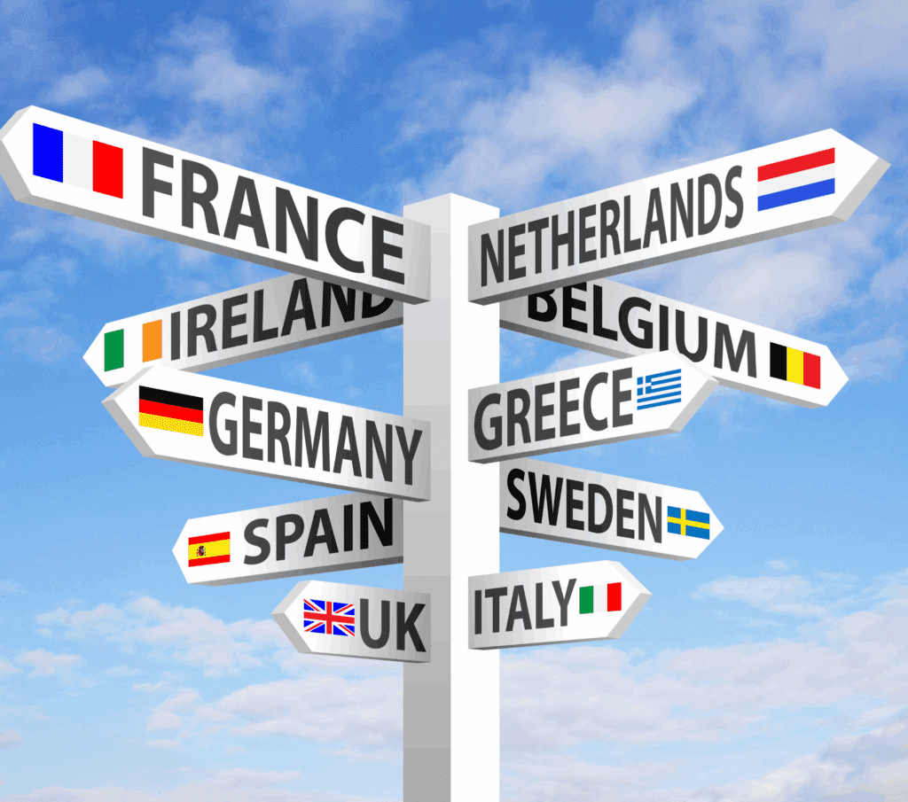 Wooden signpost with arrows pointing in different directions labeled with European countries, symbolizing the variety of travel styles and destinations to explore across Europe.