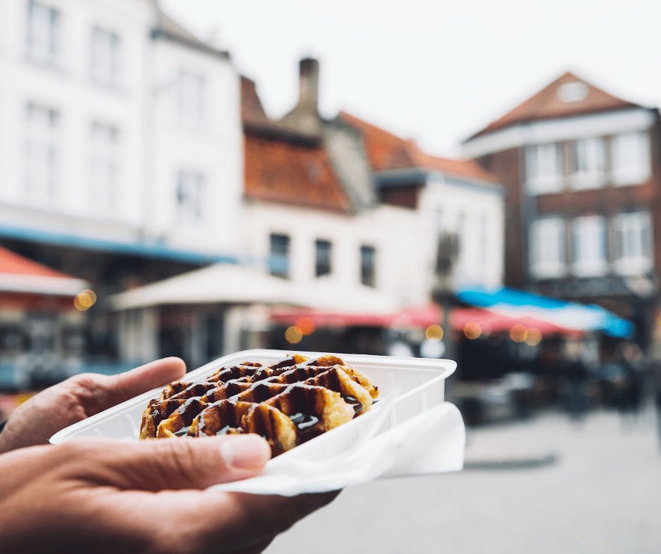 Close-up of a freshly made stroopwafel in Ghent, Belgium, with caramel filling and crisp waffle layers, served warm from a local street vendor. 