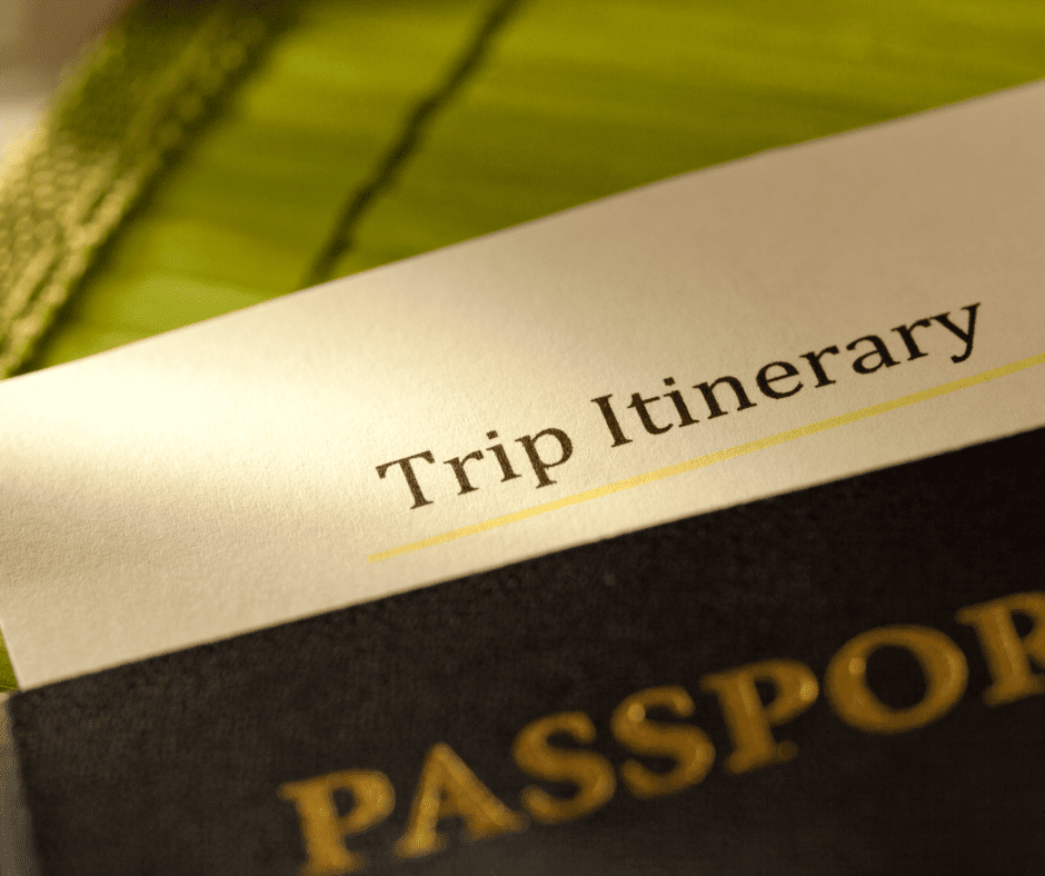 Close-up of a passport placed on top of a printed trip itinerary, symbolizing international travel planning and preparation.